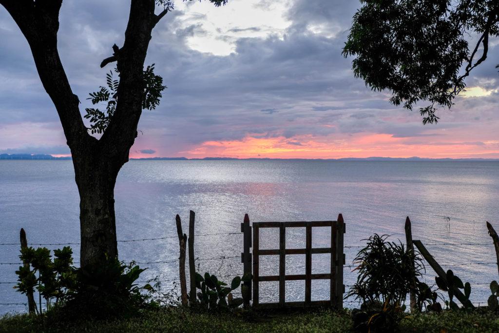 View of sunset behind a fence at Punta de Guavas